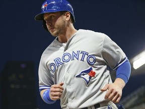 Blue Jays' Justin Smoak heads to the dugout after he scored on a single by Teoscar Hernandez off Twins pitcher Ryne Harper during sixth inning MLB action in Minneapolis, Tuesday, April 16, 2019.
