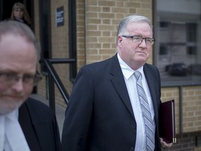 Former Kingsville fire chief Bob Kissner, right, walks out of the  Superior Court of Justice building in downtown Windsor with his lawyer, Ken Marley, after being found guilty of nine sex-related charges on April 16, 2019.