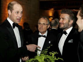 Britain's Prince William, left, talks with David Beckham, second right, during the global premiere of Netflix's "Our Planet" at the Natural History Museum in London, Thursday April 4, 2019.