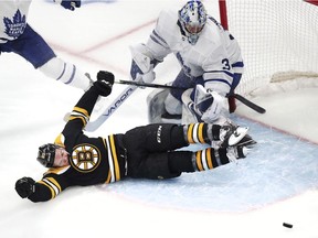 Boston Bruins center Karson Kuhlman slides through the crease after a save on his shot by Toronto Maple Leafs goaltender Frederik Andersen (31) during the third period of Game 1 of an NHL hockey first-round playoff series Thursday, April 11, 2019, in Boston.