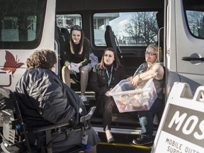 Colleen Renaud, left, talks with members of the Mobile Outreach and Support Team (MOST), from left, Stephanie Hill, Shayna Samson, and Sue LaButte, that was parked at the corner of University Ave. East and Glengarry Ave., Wednesday, April 3, 2019.