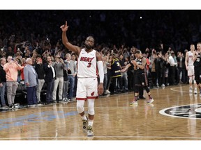 Miami Heat guard Dwyane Wade (3) acknowledges the crowd's cheers after playing in the final NBA basketball game of his career, against the Brooklyn Nets on Wednesday, April 10, 2019, in New York.