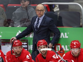 FILE - In this Feb. 26, 2019, file photo, Detroit Red Wings head coach Jeff Blashill watches against the Montreal Canadiens in the second period of an NHL hockey game, in Detroit. The Red Wings and coach Jeff Blashill have agreed on a two-year contract extension. The 45-year-old Blashill is in his fourth season as coach of the storied franchise, which will miss the playoffs for the third straight year.