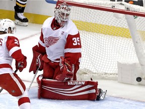 Detroit Red Wings goaltender Jimmy Howard (35) looks back to see a shot by Pittsburgh Penguins' Jake Guentzel get behind him for a goal during the first period of an NHL hockey game in Pittsburgh, Thursday, April 4, 2019.