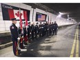 Members of the Windsor Fire Dept. and Detroit Fire Dept. pose with a silver trumpet at the international boundary line inside of the Windsor/Detroit tunnel on Tuesday, April 16, 2019. The photo was taken to commemorate a massive fire that occurred 170 years ago on the border that required the efforts of both departments.