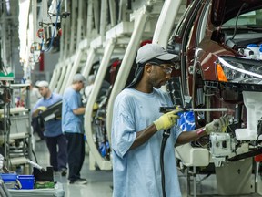 FILE - In this June 12, 2013, file photo, workers assemble Volkswagen Passat sedans at the German automaker's plant in Chattanooga, Tenn.