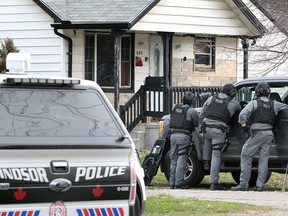 Members of the Windsor police Emergency Services Unit (ESU) keep watch over 692 Capitol St. in a standoff situation on April 18, 2019.