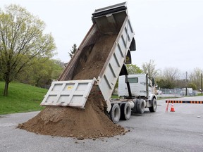 A dump truck delivers sand to a parking lot at Riverside Kiwanis Park (next to east Windsor's toboggan hill east of Riverdale Avenue) on May 7, 2019. The sand will be available for sandbagging, starting Wednesday, for city shoreline residents dealing with potential flooding.