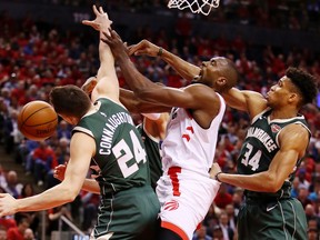 Serge Ibaka #9 of the Toronto Raptors battles for the ball with Pat Connaughton #24 and Giannis Antetokounmpo #34 of the Milwaukee Bucks during the second half in game four of the NBA Eastern Conference Finals at Scotiabank Arena on May 21, 2019 in Toronto, Canada.
