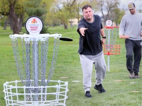 Justin Warnock, left, practises his disc throwing at Lakewood disc golf course Monday May 13, 2019.