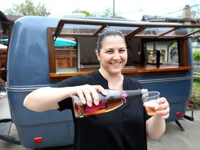 Windsor Eats co-owner Pina Ciotoli serves wine from her 1973 Trillium camper which has been totally retrofitted to become their food and beverage vehicle.