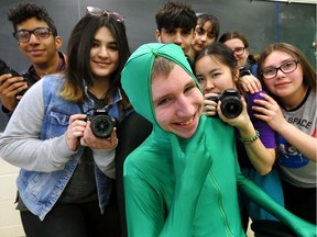 Provincially honoured Kennedy Collegiate Institute  students pose after their video "Training Works" won first-place recently . In photo, dressed in a bright green suit to simulate a hazard, actor Phoenix Lambier, centre, is surrounded by other video production students (clockwise) Saina Ahmadi,  Kahless Christopher, left, Yuvi Gill,  Sara Al Burkat, Tasha Dang, Jasmine Katona and Liana Hockin, right.   See Dalson Chen story.