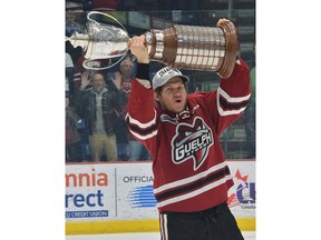 Windsor's Owen Lalonde raises the J. Ross Robertson Cup after helping the Guelph Storm beat the Ottawa 67's 8-3 on Sunday to clinch the OHL title and a spot in the Memorial Cup.