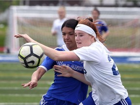 Windsor, Ontario. May 22, 2019. Villanova's Alexis Bernardes, left, battles St. Anne Saints Ashley Ditchfield in WECSAA senior girls' AAA Final at Holy Names Wednesday.  See Parker story.