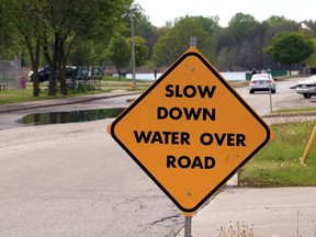 Motorists are warned about standing water in the roadway and parking lot near Gil Maure Park in LaSalle on Wednesday, May 22, 2019.