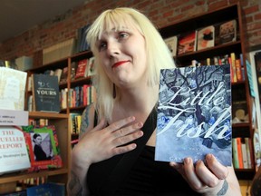 Casey Plett talks with guests during Spring Fiction Launch at Biblioasis Thursday.  Casey Plett holds Little Fish which won Amazon Canada First Novel Award.