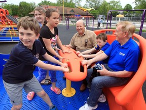 Tanner Kell, 11, left, Jamie Lynn Ashe, 10 and Leah Laporte, 10, provide the pulling power whlie Rick Farrow, Maddex Kell, 10, and Tom Laporte, right, enjoy the smooth ride on Aeroglider at Farrow Riverside Miracle Park Playground in Riverside Friday.