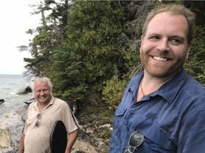 In this undated photo, maritime historian Cris Kohl, left, and show host Josh Gates on their way to getting soaked along the rocky shoreline of western Manitoulin Island where wreckage from the alleged Griffon washed ashore.