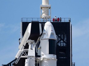 In this file photo taken on March 1, 2019, the SpaceX Falcon 9 rocket with the unmanned Crew Dragon capsule on its nose sits at Kennedy Space Center in Florida.