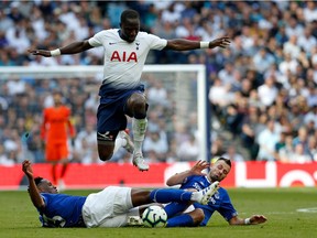 Tottenham Hotspur's French midfielder Moussa Sissoko (C) is tackled by Everton's Colombian defender Yerry Mina (L) and Everton's French midfielder Morgan Schneiderlin (R) during the English Premier League football match between Tottenham Hotspur and Everton at Tottenham Hotspur Stadium in London, on May 12, 2019.