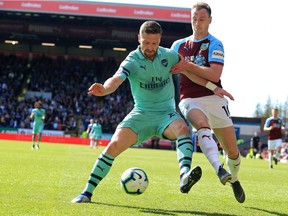 Arsenal's German defender Shkodran Mustafi (L) vies with Burnley's English striker Ashley Barnes (R) during the English Premier League football match between Burnley and Arsenal at Turf Moor in Burnley, north west England on May 12, 2019.