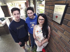 St. Anne Catholic High School students Riley Carmichael, left, and Brayden Tessier pose with Patricia Murphy at her Niagara St. home in Windsor on Friday, May 17, 2019. The students were involved in a research project involving local veterans and determined that Samuel Berger a WW II veteran lived at the home. Murphy decided to have a permanent plaque made and hung near the front door.