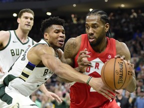 Milwaukee Bucks forward Giannis Antetokounmpo (34) defends as Toronto Raptors forward Kawhi Leonard (2) controls the ball during second half action in Game 5 of the NBA Eastern Conference final in Milwaukee on Thursday, May 23, 2019.