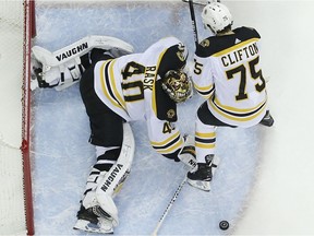 Boston Bruins' Tuukka Rask, of Finland, makes a save as teammate Connor Clifton helps guard the goal against Columbus Blue Jacket players looking for the rebound during the second period of Game 6 of an NHL hockey second-round playoff series on May 6, 2019, in Columbus, Ohio.