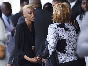 Justice Maya Singleton, left, daughter of the late film director John Singleton, greets guests at a memorial service for Singleton at Angelus Funeral Home, Monday, May 6, 2019, in Los Angeles. Singleton died on April 29 following a stroke.