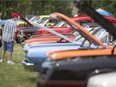 Car enthusiasts check out the cars on display at the Can-Am Nationals 42nd Anniversary Car Show, presented by Windsor Area Street Rods Inc., at  Gil Maure Park in LaSalle, Sunday, May 29, 2016.