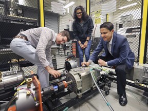 University of Windsor engineering students Donovan O'Donnell, left, and Shruthi Mukundan, centre, are shown with professor Narayan Kar at the Centre for Hybrid Automotive Research and Green Energy (CHARGE) at the school on Friday, May 24, 2019.