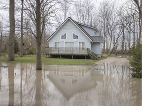 A home with a flooded front lawn is pictured on Cotterie Park Rd. as waterfront homes continue to flood, Wednesday, May 1, 2019.