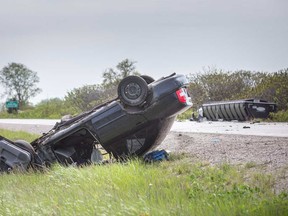 A car rests on its roof and a transport truck sits in a ditch on Highway 3 east of Graham Side Road near Kingsville on May 23, 2019.