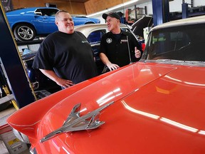 Steve Crawford of Crawford General Contracting (left) and Bill Darmon of Xcentrick Autosports Inc. (right) talk over the hood of a classic car on May 16, 2019. Crawford says he'll step up as the title sponsor to keep the Downtown Windsor BIA's Ouellette Car Cruise happening this summer.