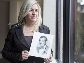 Genevieve Cano holds a portrait of her father Agustin Cano, whose murder in 1984 was solved thanks to an anonymous tip.