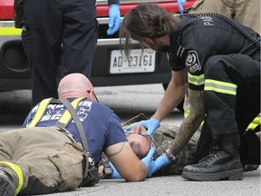 Emergency personnel care for a cyclist who was struck on Friday, May 24, 2019 at the intersection of University Avenue and Cameron Avenue.