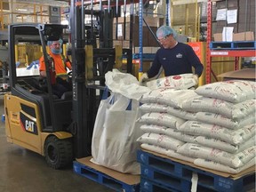 Workers at the Dainty Foods facility in west Windsor lare shown May 6, 2019, loading bags of rice for shipping.
