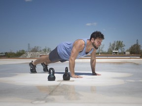 Dan Bosco, owner and head coach at Windsor Crossfit, performs a workout during Keep Dan on the Roof, Tuesday, May 14, 2019.  Bosco is doing workouts and challenges to raise money for the Heart Breaker Challenge.