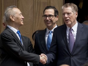 Treasury Secretary Steve Mnuchin, center, and United States Trade Representative Robert Lighthizer, right, speak with Chinese Vice Premier Liu He, left, as he departs the Office of the United States Trade Representative in Washington, Friday, May 10, 2019.