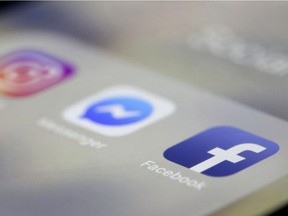 In this March 13, 2019, file photo, Facebook, Messenger and Instagram apps are are displayed on an iPhone in New York. Facebook co-founder Chris Hughes says it's time to break up the social media behemoth. He says in a New York Times opinion piece that CEO Mark Zuckerberg has allowed a relentless focus on growth that crushed competitors "to sacrifice security and civility for clicks."