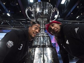 Calgary Stampeders defensive back Patrick Levels, left, and Stampeders wide receiver Bakari Grant eye up the Grey Cup during media day ahead of the 106th Grey Cup in Edmonton on Nov. 22, 2018.