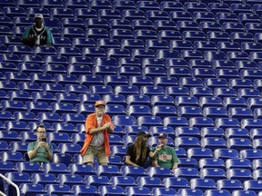 Fans watch a baseball game between the Miami Marlins and San Francisco Giants, Thursday, May 30, 2019, in Miami. Major League Baseball's average attendance of 26,854 is 1.4% below the 27,242 through the similar point last season, which wound below 30,000 for the first time since 2003. Baltimore, Cincinnati, Minnesota and Tampa Bay set stadium lows this year. Kansas City had its smallest home crowd since 2011, and Toronto and San Francisco since 2010. Miami and the Rays drew 12,653 Wednesday night _ combined.