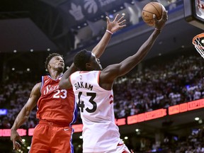 Philadelphia 76ers guard Jimmy Butler (23) reaches to try and block Toronto Raptors forward Pascal Siakam (43)during second half NBA Eastern Conference semifinal action in Toronto on Sunday, May 12, 2019.