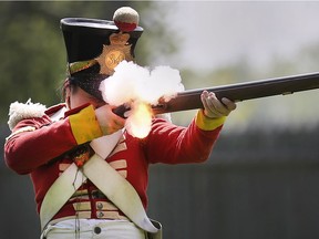 Diane Ye a historic re-enactor fires a musket at the Fort Malden National Historic Site on Saturday, May 18, 2019 during the opening weekend of the season.