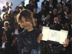 Director Mati Diop, winner of the grand prix award for the film 'Atlantics,' poses for photographers during a photo call following the awards ceremony at the 72nd international film festival, Cannes, southern France, Saturday, May 25, 2019.