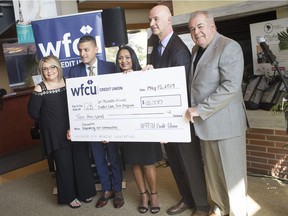 From left, Linda Santos, office manager at T2B, Eddie Francis, president and CEO of Windsor Family Credit Union, Amber Hunter, executive director at T2B, Mike Ivkovic, associate vice president, strategic alliances, Concentra, and Marty Gillis, chair of the board at WFCU, pose for a photo with a cheque for $10,000 from Concentra to the WFCU's Transition to Betterness Dr. Michelle Prince Comfort Care Tote Program at the Windsor Regional Cancer Centre, Wednesday, May 15,  2019.
