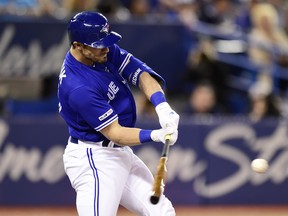 Blue Jays left fielder Randal Grichuk hits a three-run homer to centre field last night against the White Sox. (The Canadian Press)