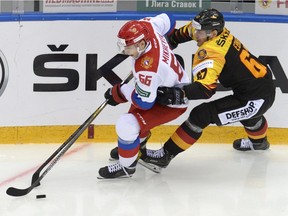 Germany's Bernhard Ebner, right, and Russia's Ilya Mikheyev fight for the puck during a Euro Ice Hockey Challenge match between Russia and Germany in Sochi, Russia, April 6, 2018. The Toronto Maple Leafs have signed Russian forward Mikheyev to a one-year entry level contract.