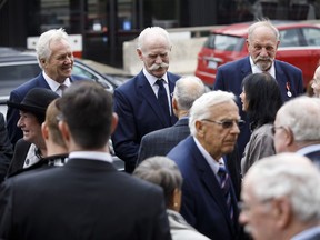 Toronto Maple Leafs alumni Darryl Sittler, left, Lanny McDonald and Eddie Shack greet mourners outside the church following the funeral mass for NHL legend Leonard Patrick "Red" Kelly in Toronto, May 10, 2019.