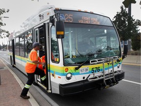 In this Oct. 4, 2017, file photo, a Transit Windsor bus picks up a passenger on Malden Road in LaSalle.